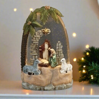 Lighted nativity globe with palm trees