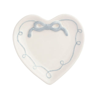 Heart-shaped ceramic plate with blue decorative elements on a white background