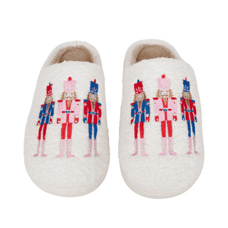Pair of slippers with nutcracker design on a white background
