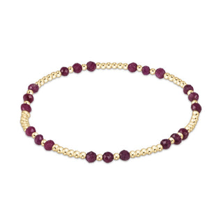 Bracelet with gold and purple beads on a white background
