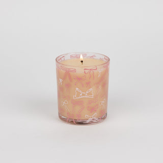 Pink candle with decorative designs on a white background