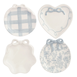 Set of four decorative plates with blue patterns on a white background