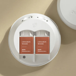 DUO Cinnamon Woods fragrance refills in a white container on a beige background