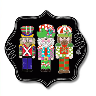 Decorative sign with three colorful Nutcrackers on a black background, accompanied by a ruler for scale.