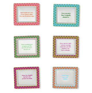 A collection of six porcelain desk trays with colorful dot patterns around the border and humorous texts in the center.