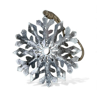 Decorative snowflake ornament with a textured surface on a white background