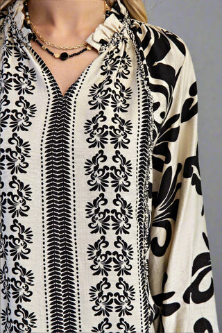 Black and white patterned garment with intricate designs on a plain background