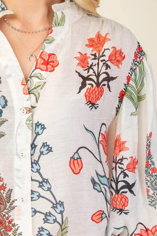 Floral patterned shirt with red, black, and green flowers on a white background