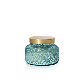 Blue glass jar with a gold lid on a white background