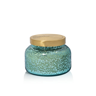 Blue glass jar with a gold lid on a white background